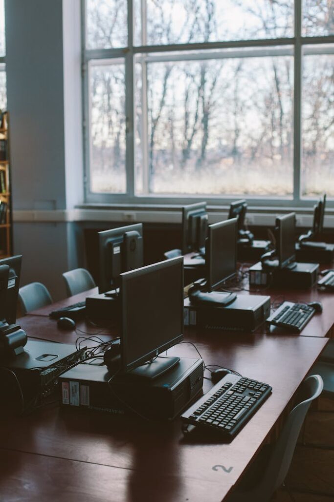 Photo Of Computers Near Windows